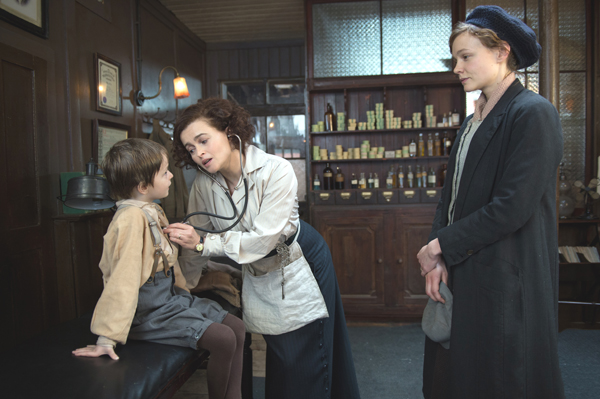Maud's son George (Adam Michael Dodd) gets attended to by Edith Ellyn (Helena Bonham Carter) in Suffragette