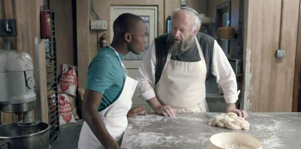 Ayyash (Jerome Holder) and Nat (Jonathan Pryce) go over baking techniques