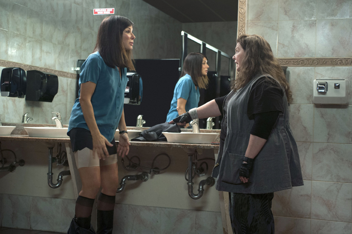 Sarah explains and displays the magic properties of Spanx to her new partner, Boston Detective Shannon
