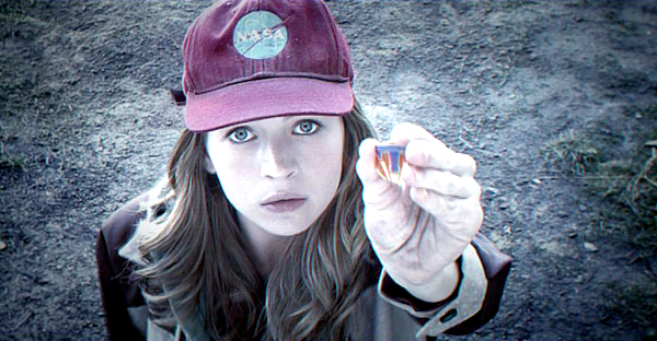 Casey (Britt Robinson) holds up the magical pin in TOMORROWLAND