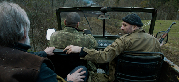 Chechen mercenaries Ahmed (Giorgi Nakhashidze) and Ibragim (Kakha Arevadze) give Ivo a ride to his house