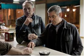 Director Anton Corbjn and Clooney go over a scene 