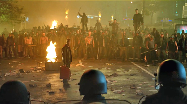 Dane DeHaan as Trip in the middle of a protest