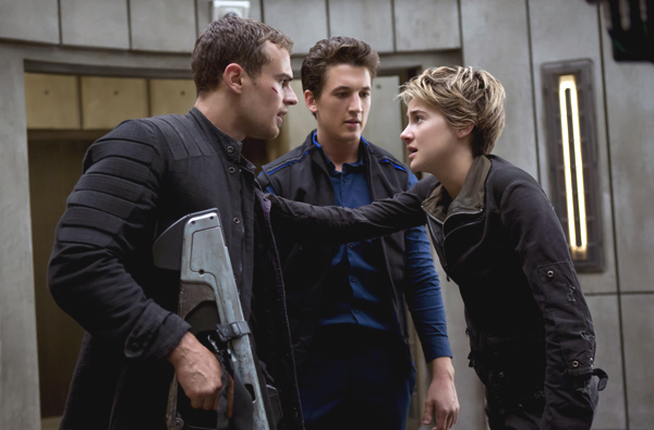 Four (Theo James, left), Peter (Miles Teller, center), and Tris (Shailene Woodley) in INSURGENT
