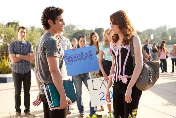 Woodchuck Todd (Penn Badgley) and Olive (Emma Stone) chat while Olive gets picketed