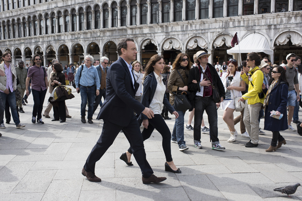 Langdon (Tom Hanks) and Sienna (Felicity Jones) make their way through St. Marks Square in Venice in Columbia Pictures' INFERNO.