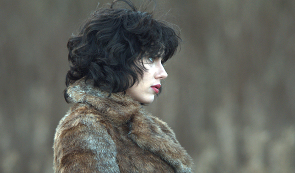 Isserley (Scarlett Johansson) walks along a deserted road in her fur coat. All Photos courtesy of A24