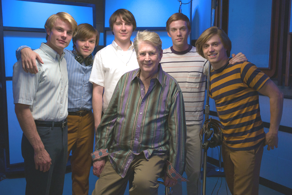 The real Brian Wilson surrounded by the cast of Love & Mercy
